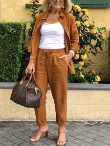 Fall casual two-piece set featuring brown linen shirt and matching trousers on model