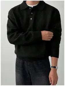 Close-up of a men's black knit Polo sweater with button collar detail