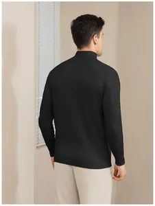 Back view of a men's black slim-fit mock neck sweater in a minimalist indoor setting.