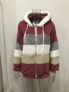 Close-up of women's color block plush hooded jacket featuring soft fleece patchwork design