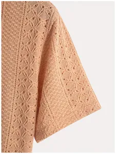 Close-up detail of the textured geometric knit pattern on a men's polo shirt sleeve.