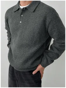 Close-up detail of a men's dark grey polo collar knit sweater featuring a buttoned neckline