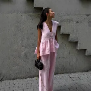 Model wearing an elegant pink cotton V-neck sleeveless vest and wide-leg trousers set