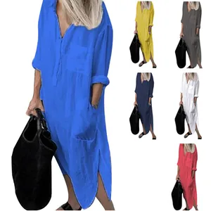 Detail of elegant solid color long sleeve shirt dress with side slits and pockets.