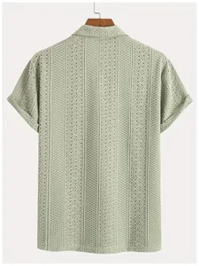 Macro view of the light green knitted texture on a men's breathable short sleeve shirt