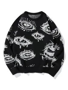 Detailansicht eines schwarzen Strickpullovers mit markantem weißem Grafikaugenmuster