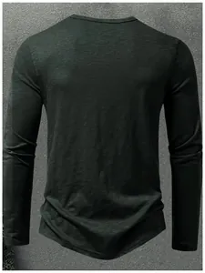 Back view of a dark green muscle fit long sleeve T-shirt with textured cotton fabric