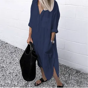Elegant navy blue long-sleeved shirt dress featuring side slits and button detail