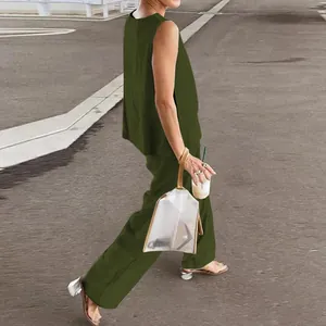 Macro view of olive green two-piece set featuring sleeveless top and wide-leg trousers