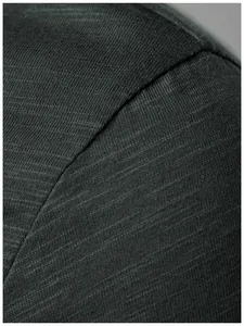 Detailed close-up of the breathable dark green fabric texture of a men's Henley T-shirt
