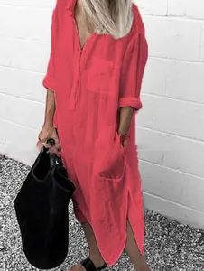 Side view of pink long-sleeved maxi shirt dress with side slits and deep pockets