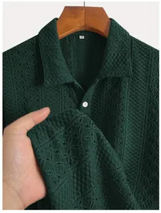 Close-up detail of dark green men's knit shirt showing textured vertical stripe pattern