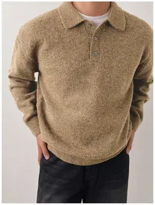 Close-up view of a brown men's polo neck knit sweater with textured fabric detail.