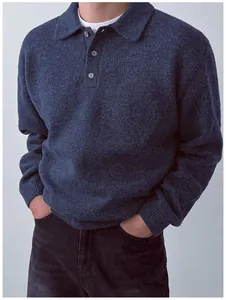 Macro detail of a navy blue knit polo sweater for men, showcasing soft wool texture.
