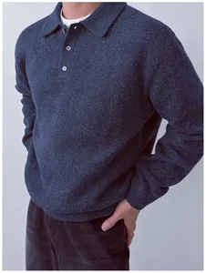Close-up of a men's navy blue knit polo sweater with buttoned collar and soft texture.