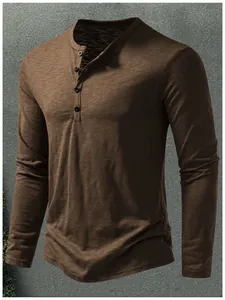 Close-up view of men's brown long sleeve Henley T-shirt with textured slub cotton fabric