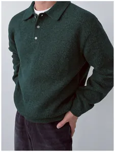 Close-up detail of a dark green men's knit polo sweater with a soft three-button lapel collar