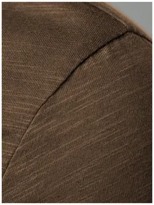 Detailed close-up view showing the high-quality brown slub fabric texture of a men's Henley shirt