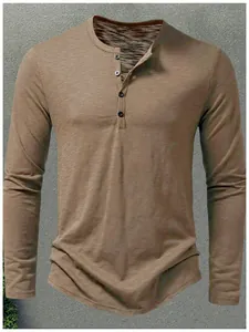 Detail of men's khaki Henley long sleeve shirt featuring a buttoned placket and textured fabric.
