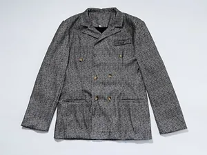 Detail view of men's double-breasted casual blazer in grey checkered textured fabric