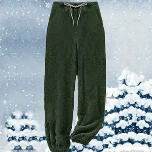 Detail view of warm dark green fleece jogger pants with cozy texture for winter lounging