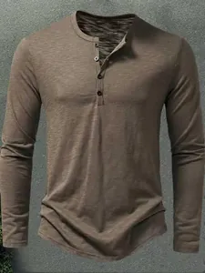 Casual men's slim fit solid color long sleeve Henley t-shirt with button neck detail