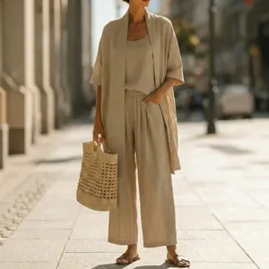 Detailed shot of women wearing a minimalist three-piece beige linen vacation set