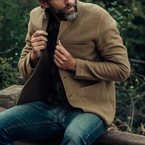 Outdoor lifestyle shot of a man wearing a brown textured casual jacket and jeans