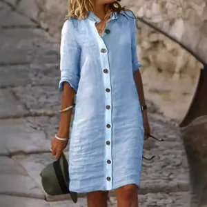 Light blue linen shirt dress with mid-sleeves and large decorative buttons for summer