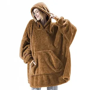Close-up view of a cozy brown fleece oversized wearable hoodie blanket shown on a model