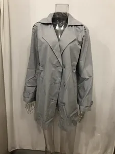 Detailed view of the front of a men's mid-length slim fit grey trench coat jacket.