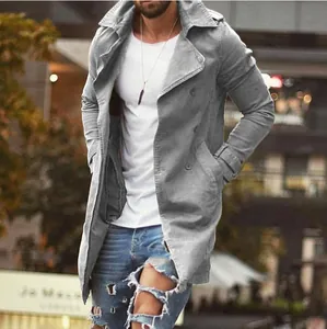 Outdoor street style view of a men's slim fit mid-length light grey trench coat.