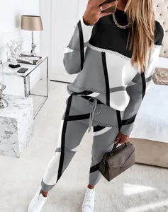 Women's 2-piece tracksuit featuring a bold grey black and white geometric block print.