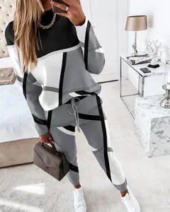Detailed view of women's geometric color-block tracksuit in a bedroom setting.