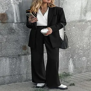 Full view of stylish black two-piece professional blazer and wide-leg trouser suit set.