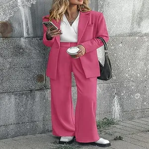 Close-up view of vibrant hot pink two-piece blazer and wide-leg trouser suit for women fashion
