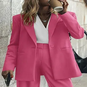 Detailed view of women's professional pink suit set in a casual street setting
