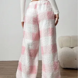 Cozy pink and white checkered fuzzy wide-leg fleece lounge pants for winter warmth.