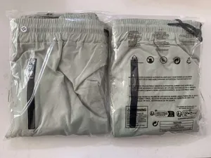 Packaging detail of men's quick-dry light green jogger pants in XXL size shown in plastic bag