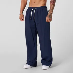 Close-up of men's navy blue wide-leg drawstring pants with breathable fabric texture