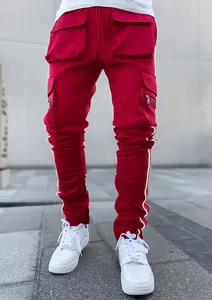 Close-up of red men's cargo pants featuring reflective side stripes and multiple utility pockets