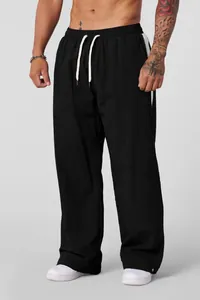 Detail view of men's loose breathable black casual trousers with white drawstring