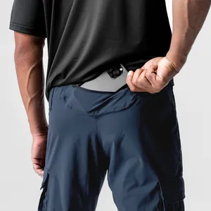 Close-up of navy blue cargo pants showing back pocket storage for a large smartphone