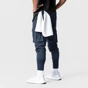 Back view of navy blue cargo joggers with multi-pockets and a towel loop feature