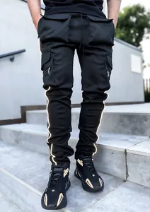 Detailed view of black reflective cargo pants with multiple pockets and elastic fabric.