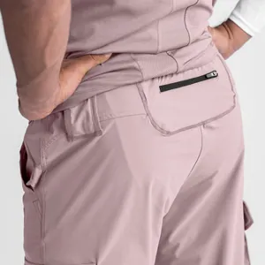 Detailed back view of men's mauve gym cargo pants highlighting the zippered security pocket