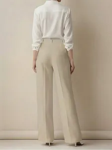Vista posteriore di eleganti pantaloni beige a vita alta in tessuto fluido con gamba dritta.