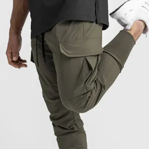 Detailed view of men's olive green cargo jogger pants showing pocket design and texture