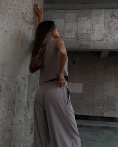Chic mauve two-piece set with sleeveless vest and draped wide-leg trousers on model