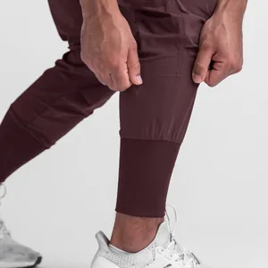 Close-up of men's athletic joggers showing ribbed cuff and lightweight fabric texture